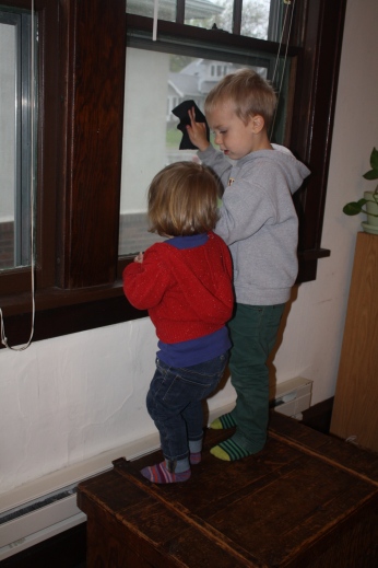 Ezra teaching Violet to clean the windows.